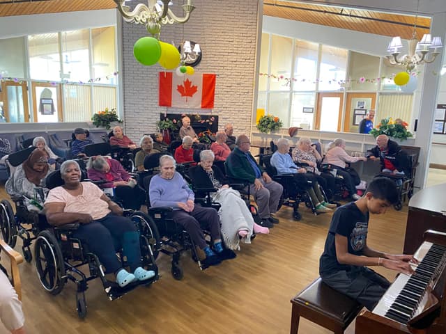 Seniors enjoying Arjun's piano performance